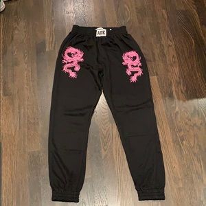 Black adika sweatpants with pink/purple dragons